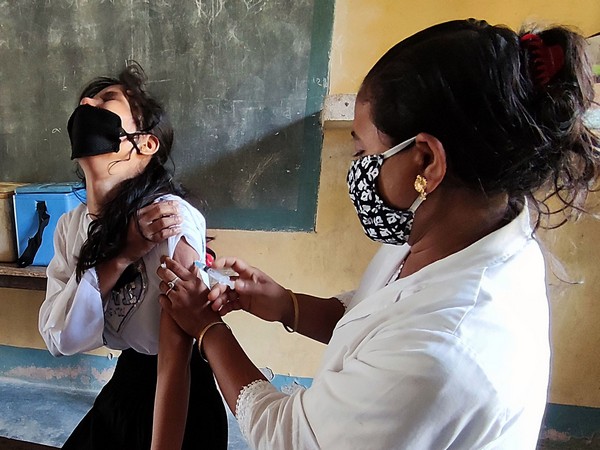 Visuals of COVID-19 vaccine being administered to a woman at a vaccination centre at Hajo in Assam's Kamrup on May 21. (Photo/ANI)
