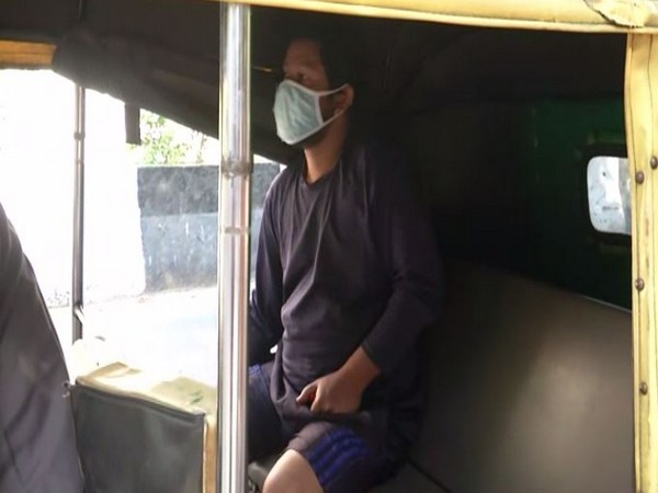 An auto plying in Delhi with a single passenger. 