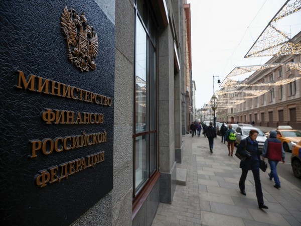 Pedestrians walk past Russia's Finance Ministry building in Moscow, Russia (Photo Credit: Reuters)