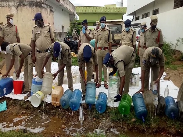Krishna Police personnel destroy liquor on Tuesday