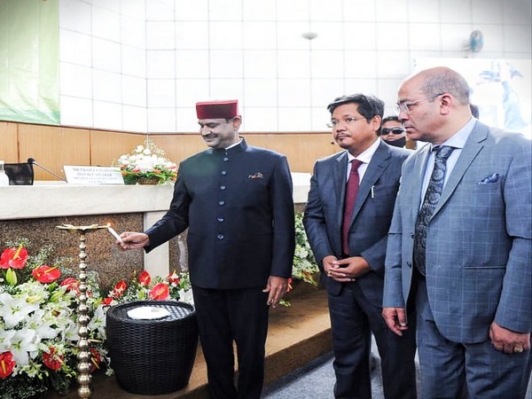 Lok Sabha Speaker Om Birla lights lamp at an event.