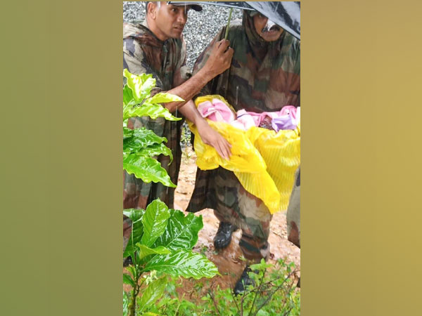 Army personnel along with the newborn rescued from Wayanad on Saturday. Photo/ANI