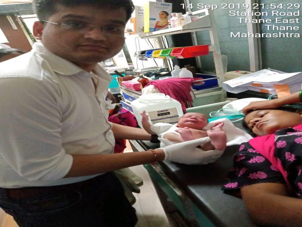 Dr Anant Darade with the woman and baby boy in Thane. 