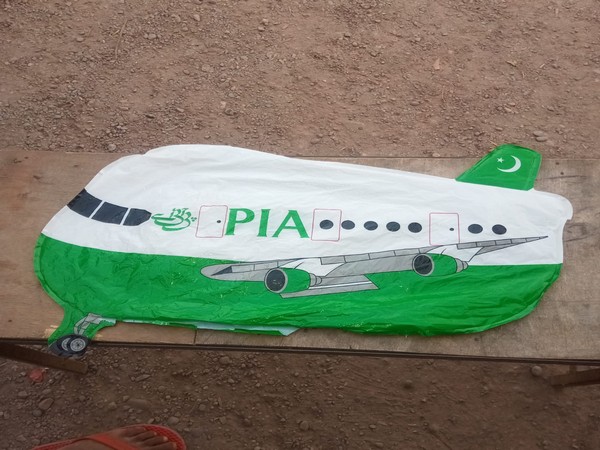 Aeroplane-shaped balloon with 'PIA' written on it 