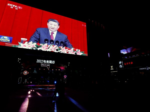 A giant screen displays news footage of Chinese President Xi Jinping delivering a speech, on New Year's Eve. (Image credit: Reuters)