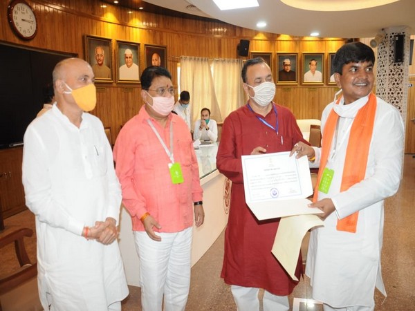 Jai Prakash Nishad receiving taking certificate from election officials on Monday. (Photo/ANI)