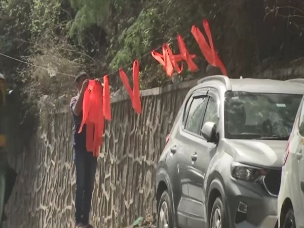 Saffron flags being removed outside JNU. (ANI/photo)
