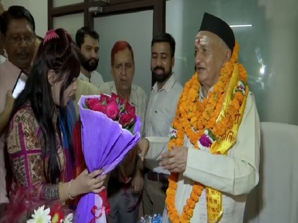 A lady offers a bouquet of flowers to Bhagat Singh Koshyari who is newly appointed governor of Maharashtra