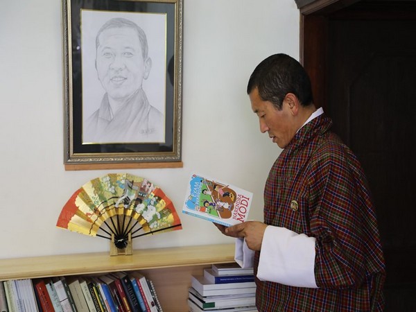 Bhutanese Prime Minister Lotay Tshering reading PM Modi's book 