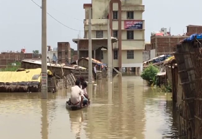 A police personnel travelling on a boat in Muzaffarpur, Bihar on July 19. Photo/ANI