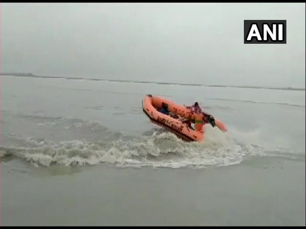 State Disaster Response Force (SDRF) is conducting a search operation after three people drowned while taking bath in Ganga river. (Photo/ANI)