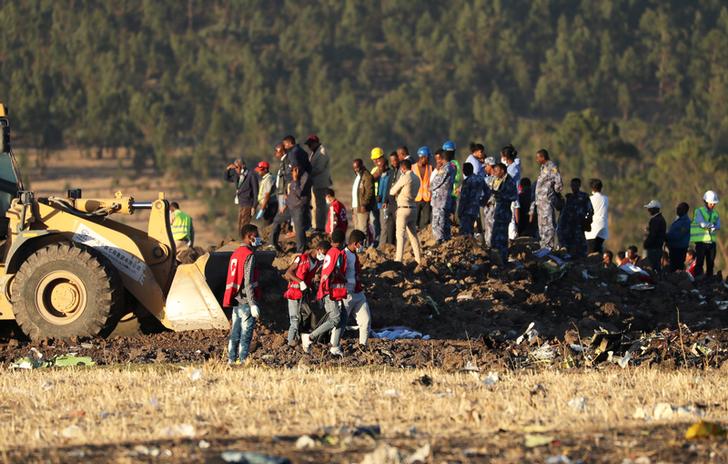 Workers scouring through debris from the site of crash in Bishoftu, Ethiopia on March 10