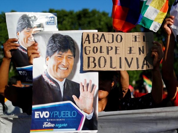 Supporters of Bolivia's ousted President Evo Morales hold a placard that reads 'Down with the coup in Bolivia' outside the US embassy in Buenos Aires, Argentina.