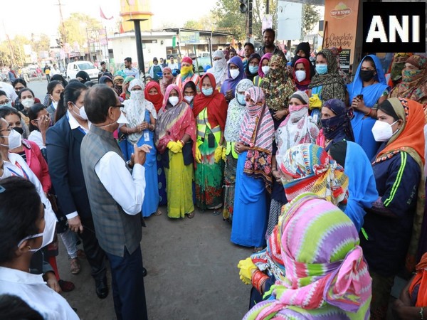 Visual of Madhya Pradesh Chief Minister Shivraj Singh Chouhan interacting with women sanitation workers on the occasion of International Women's Day