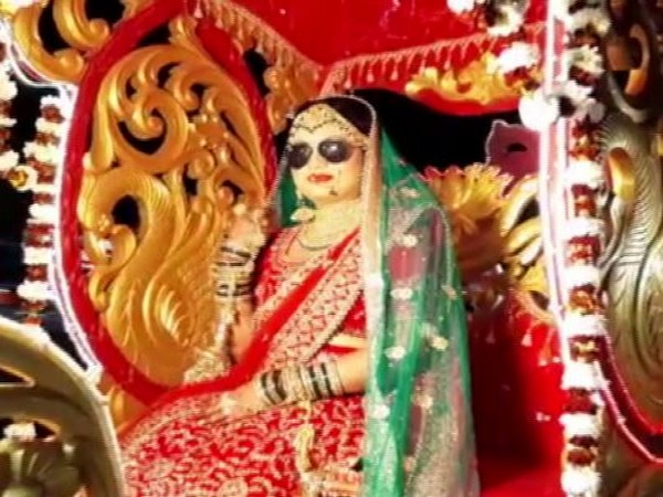 The bride was seen sitting on a chariot in her wedding saree, while donning a pair of sunglasses (Picture Courtesy: ANI)