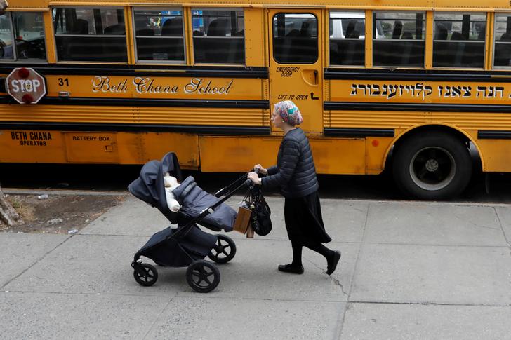 A woman with her baby in Williamsburg, Brooklyn on April 9 (Image source: Reuters)