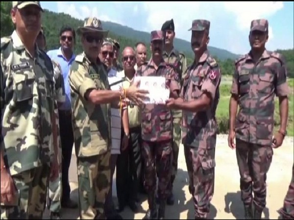 BSF and BGB personnel exchanging sweets on the eve of Bakrid along Meghalaya border. (Photo/ANI)