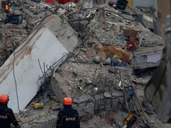 Rescue workers at the site of the building collapse in Istanbul, Turkey