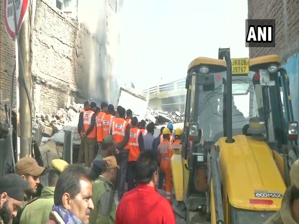 Rescue workers take out four civilians from the debris of the collapsed building in Jammu. (Photo ANI)