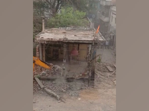 Visual of bull dozer razing the temple (Photo/ANI)