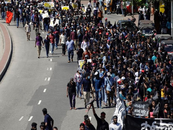 Demonstrators march towards the Sri Lankan Prime Minister Mahinda Rajapaksa's residence during a protest (Photo Credit: Reuters)
