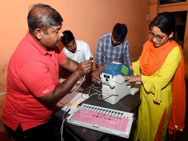 Uttar Pradesh, Oct 20 (ANI): Polling officials setting up EVMs and polling materials at a polling booth on the eve of bye-elections in Lucknow Cantt on Sunday.