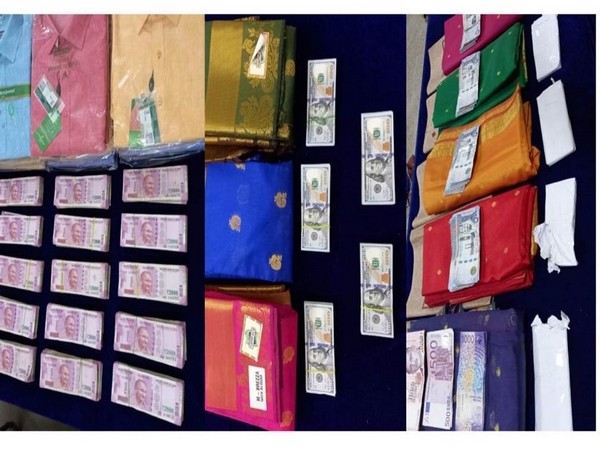 Several notes in different currencies were hidden in between saris and shirts. 