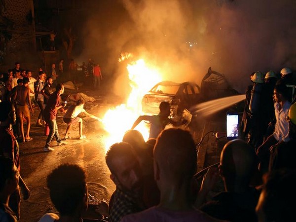 People extinguishing the flames after cars collided in Cairo on Aug 5 (Photo/Reuters)