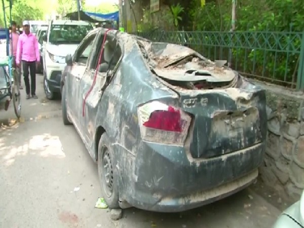 The car that got badly damaged after the 18th Century gate collapsed. Photo/ANI