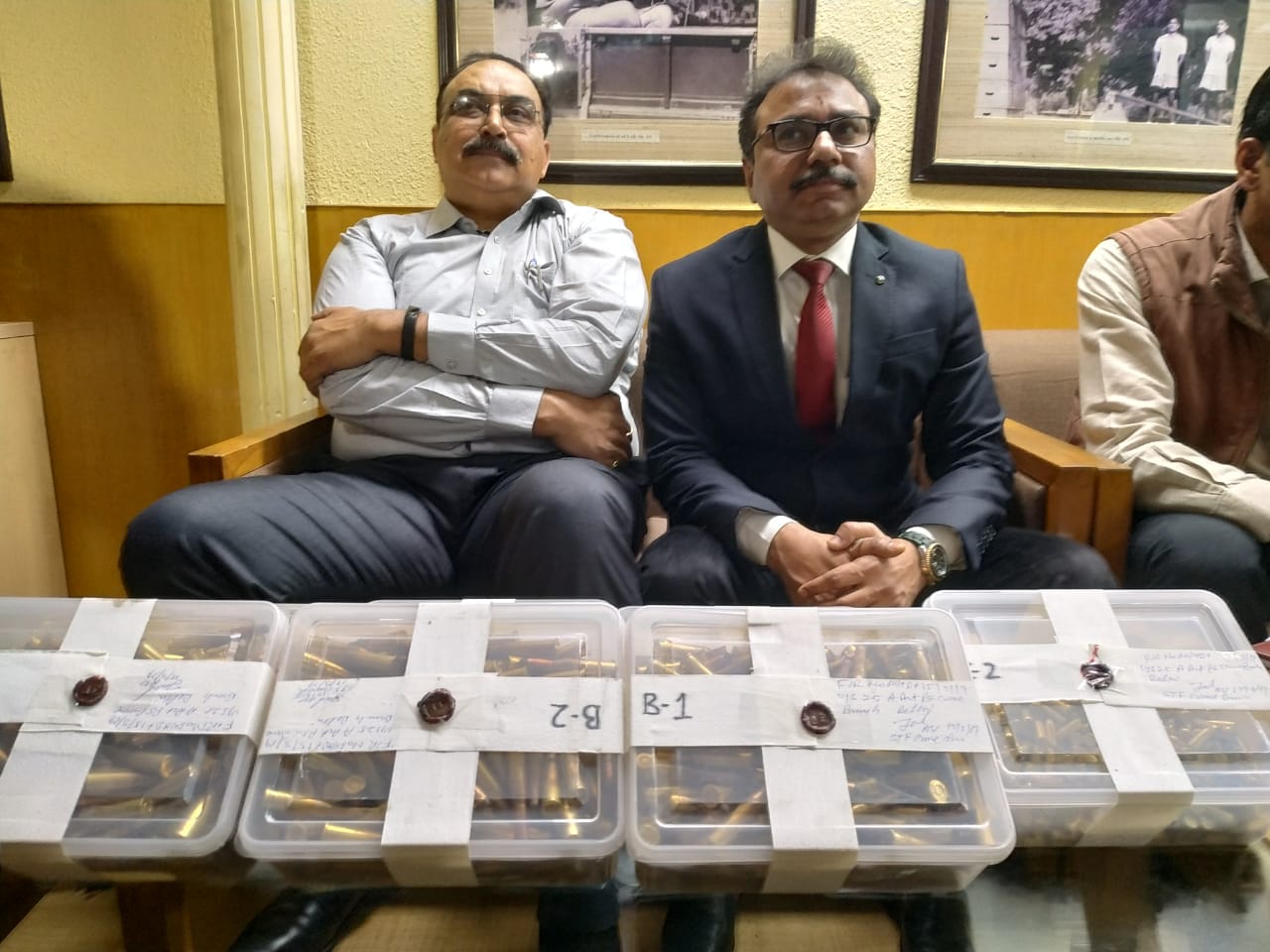 Police officials including Ram Gopal Naik (Center) with the 2000 seized live cartridges in New Delhi on Saturday. 