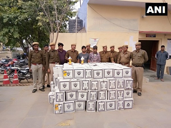 Police officials along with the seized goods and accused. Photo/ANI