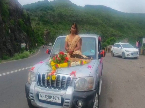 The woman sitting on a car bonnet. (Photo/ANI)