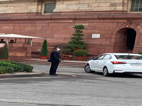 Security staff at Parliament wearing disposable glove and mask, as a precautionary measure against coronavirus. [Photo/ANI]