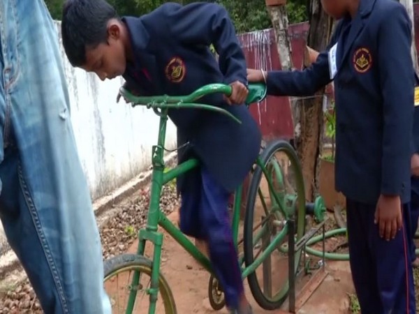 A students using the peddle powered water pump system in the primary school of Bavikai village in Karnataka's Shivamogga on Friday. Photo/ANI