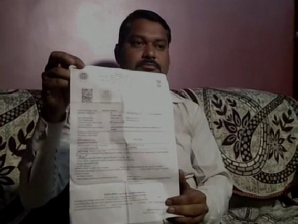 Praveen Kumar with the copy of e-challan issued to him by the traffic police in Hamirpur in Uttar Pradesh. Photo/ANI