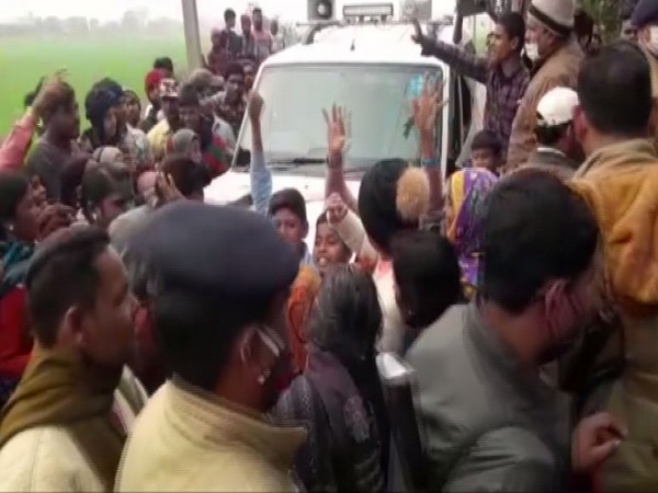 Local people in front of the minister's vehicle after the firing incident in Bihar's Champaran. (ANI/photo)