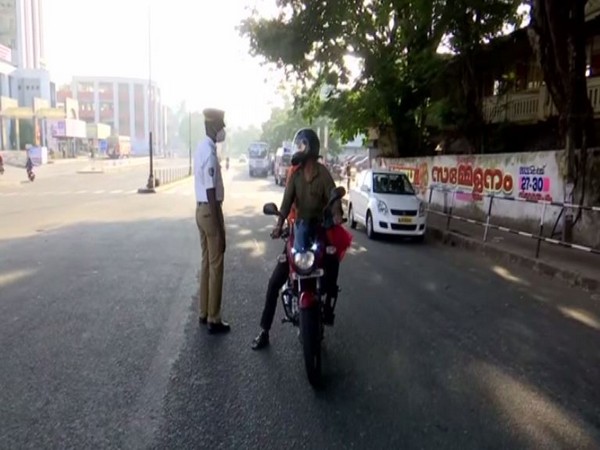 Police talking to a person on road during Sunday lockdown. (ANI/photo)