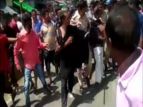 Police rescues man being thrashed by a group of locals in Kanpur on Wednesday. Photo/ANI