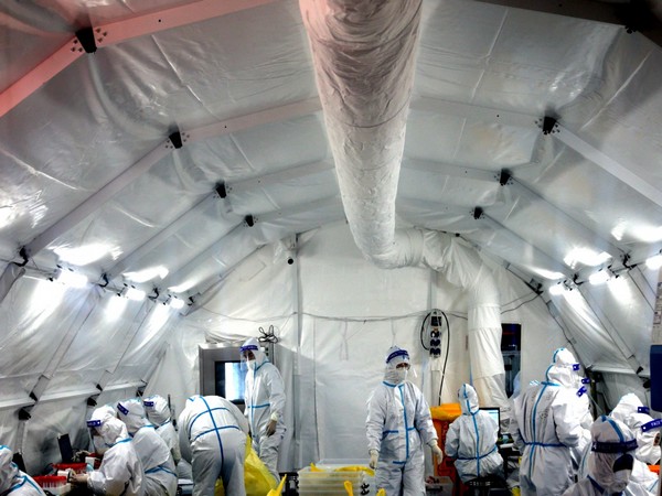 Medics inside a makeshift nucleic acid testing laboratory set up at a convention centre following the coronavirus disease outbreak in Xian, China. (Image credit: Reuters)
