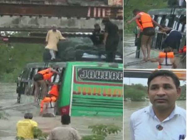 A traveller bus stuck in a sewage in Chittorgarh carrying 35 passengers. Photo/(ANI)