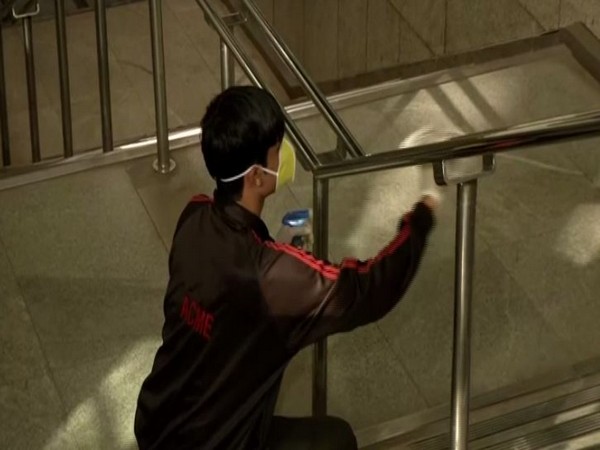 A worker sanitising Rajiv Chowk metro station staircases in New Delhi on Friday. Photo/ANI