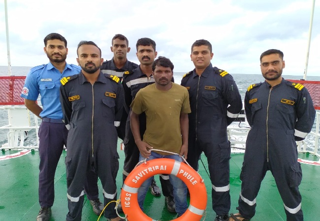 The rescued fisherman with the Indian Coast Guard officials. 