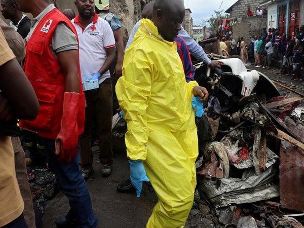 Civilians gather at the site where a Dornier 228-200 plane operated by local company Busy Bee crashed into a densely populated neighbourhood in Goma