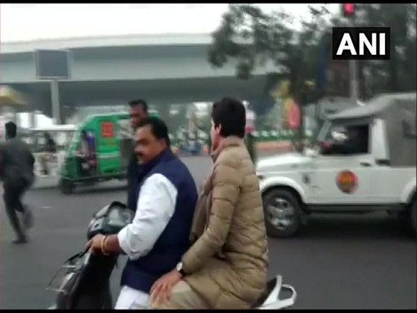 Congress leader Dheeraj Gurjar with Priyanka Gandhi Vadra on scooter on Saturday in Lucknow. Photo/ANI