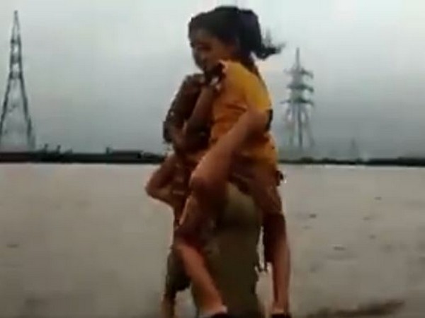 A constable was seen carrying children on his shoulders in floodwaters in Morbi district of Gujarat.