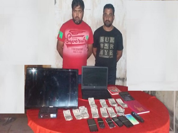 Arrested bookies along with confiscated material 