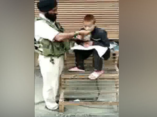 A video grab of the CRPF driver feeding a specially-abled Kashmiri boy. Photo/ANI