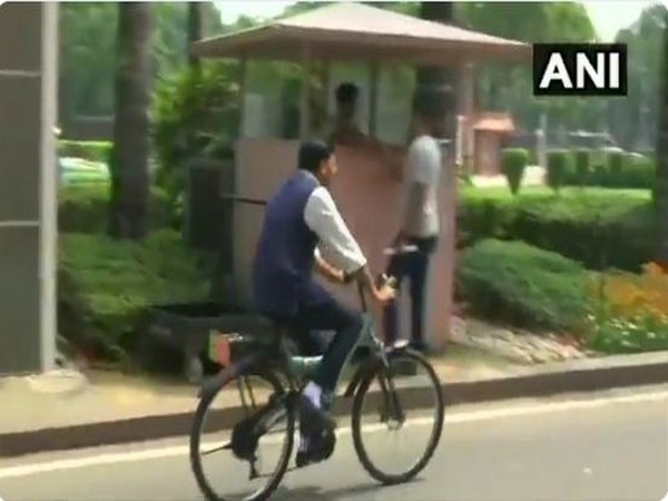 Union MInister Mansukh Mandaviya riding his bicyle to Parliament on Wednesday. (Photo/ANI)