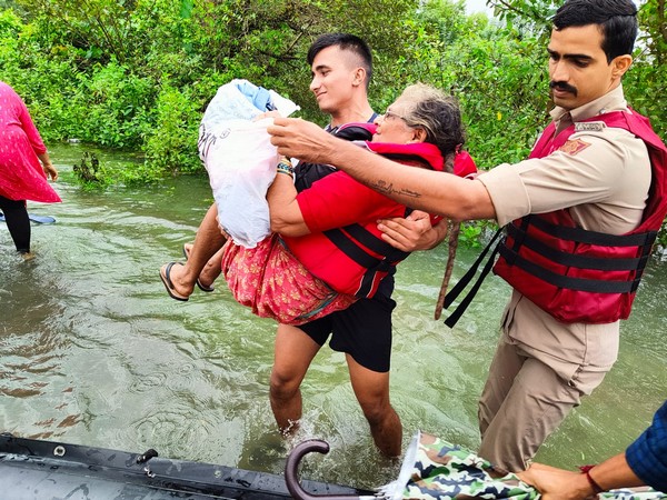 Indian Navy teams evacuating people from flood affected areas 