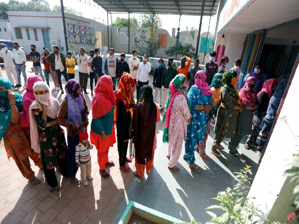Voters stand in queues to cast their votes in Gujarat Gram Panchayat Polls Shela Village of Sanand Tehsil, in Ahmedabad (Photo/ANI)